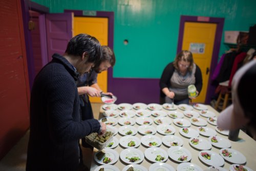 plating the greek meatballs and dolmades - "lamb meatball rolled in hazelnut flour, rice and herbs in grape leaves, tzatziki yogurt sauce"