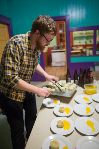 plating the Brandade Cake - "salt cod and potato cake served with tomato confit and sous vide egg yolk"